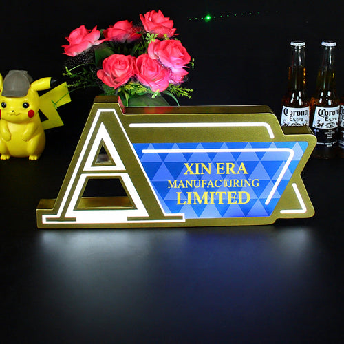 Custom gold metal LED counter sign with Augerta branding and blue geometric pattern
