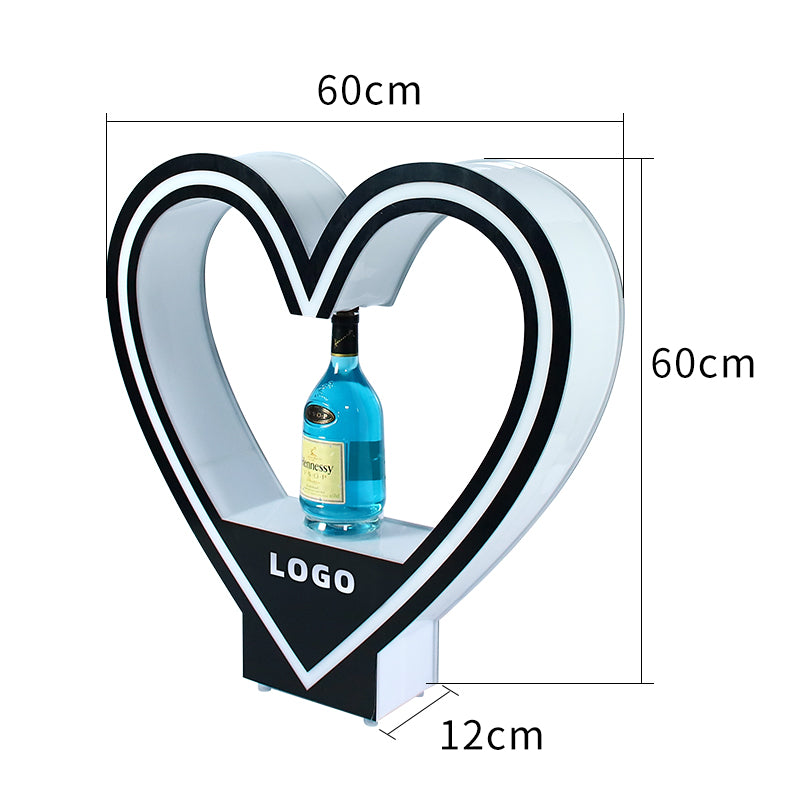 Custom heart-shaped LED bottle presenter with yellow glow lighting and bespoke brand logo for VIP nightclub service.