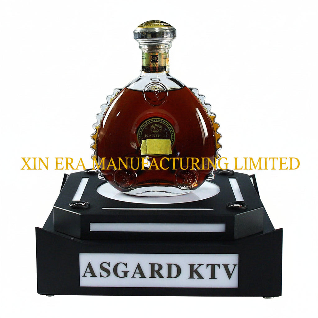 Front view of XIN ERA LED VIP bottle presenter with glowing logo on a dark nightclub background.