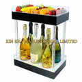 Luxury two-tier LED glowing presenter for bottles and fruit snacks, featuring illuminated crystal-filled pillars for premium nightclub VIP service.